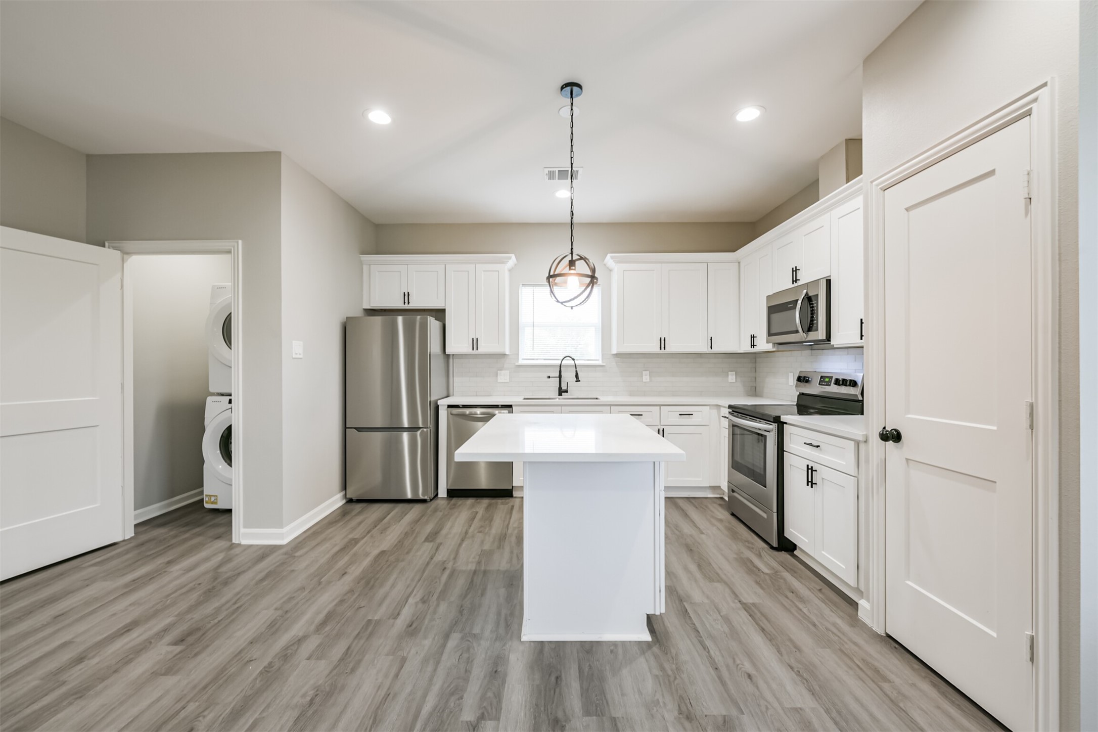 4405 Mallow Street Houston, TX 77051 - Photo 8 of 21 a kitchen with white cabinets and stainless steel appliances