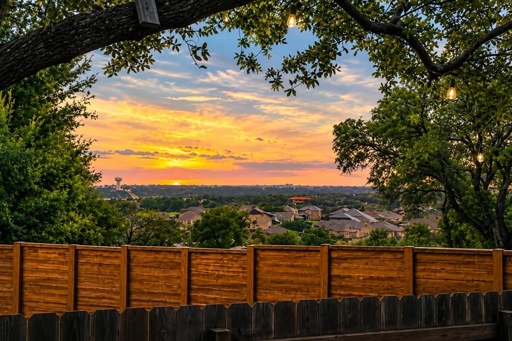 4420 Ingram Road Georgetown, TX 78628 - Photo 30 of 40 Golden sunset vistas span across the rolling hills and neighborhood treetops beyond the backyard fencing.