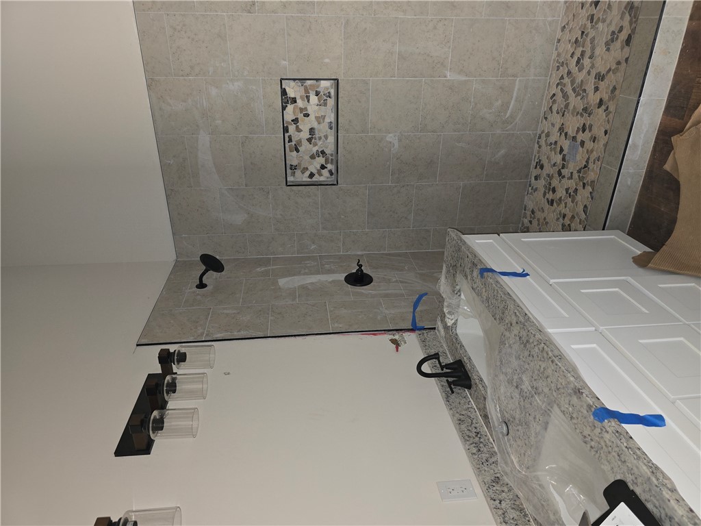 157 Hunting Hollow Road Six Mile, SC 29682 - Photo 7 of 19 Granite counters and tiled shower create a luxurious bathroom retreat.