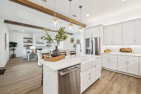 a kitchen with white cabinets and refrigerator