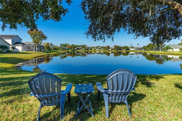 a view of a chairs in patio with a lake view
