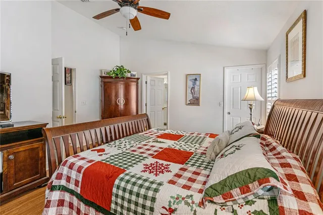 a bedroom with bed and wooden floor