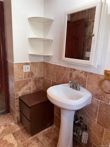 a bathroom with a sink toilet and a mirror