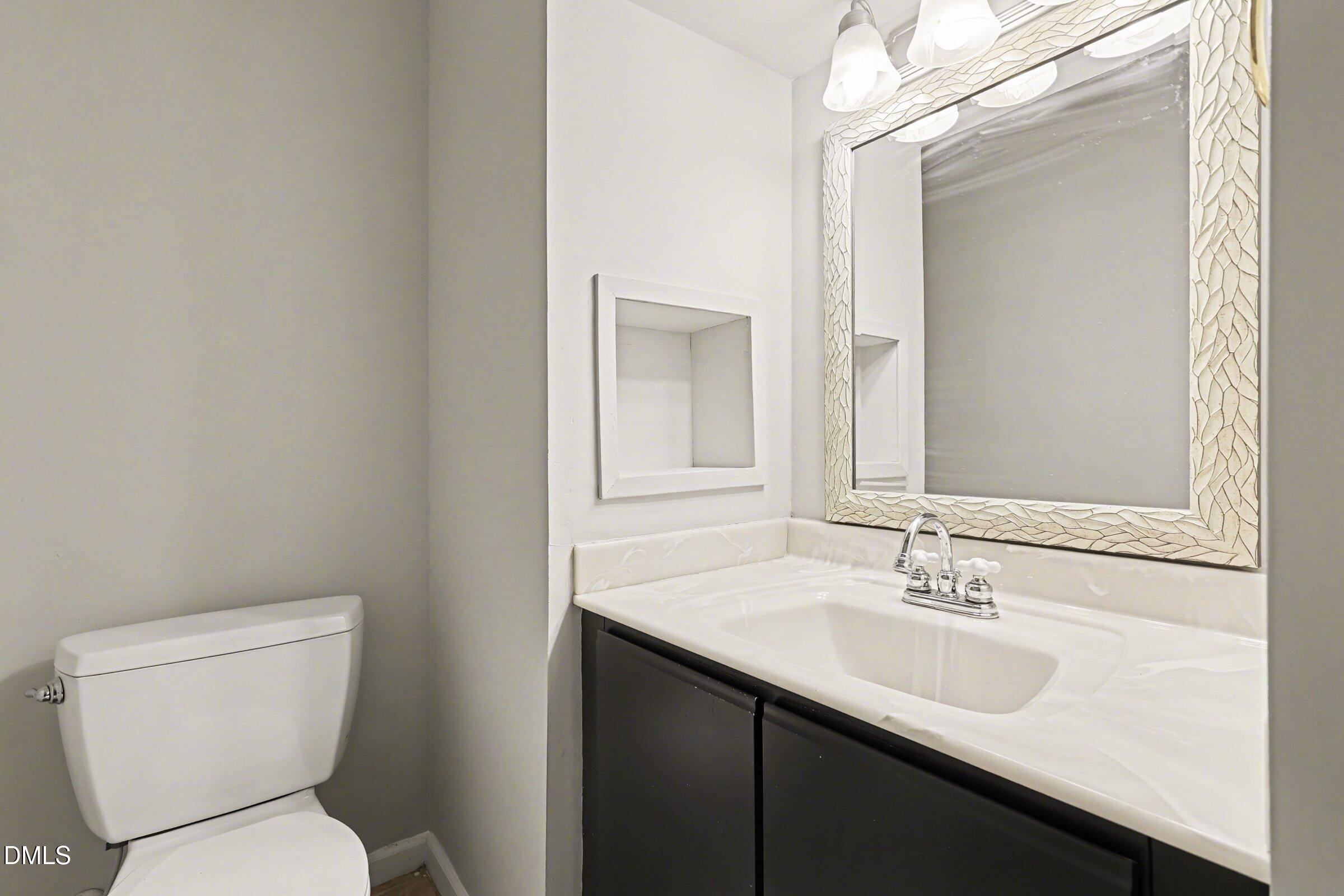 5645 Hamstead Crossing Raleigh, NC 27612 - Photo 23 of 35 a bathroom with a sink toilet and mirror