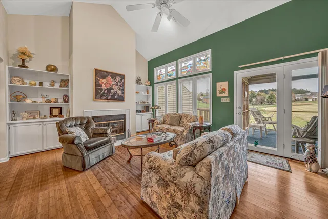 a living room with furniture and a floor to ceiling window