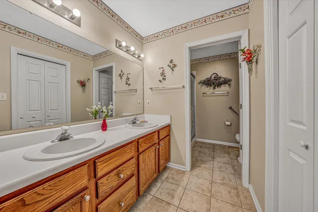 a bathroom with a sink double vanity and a mirror