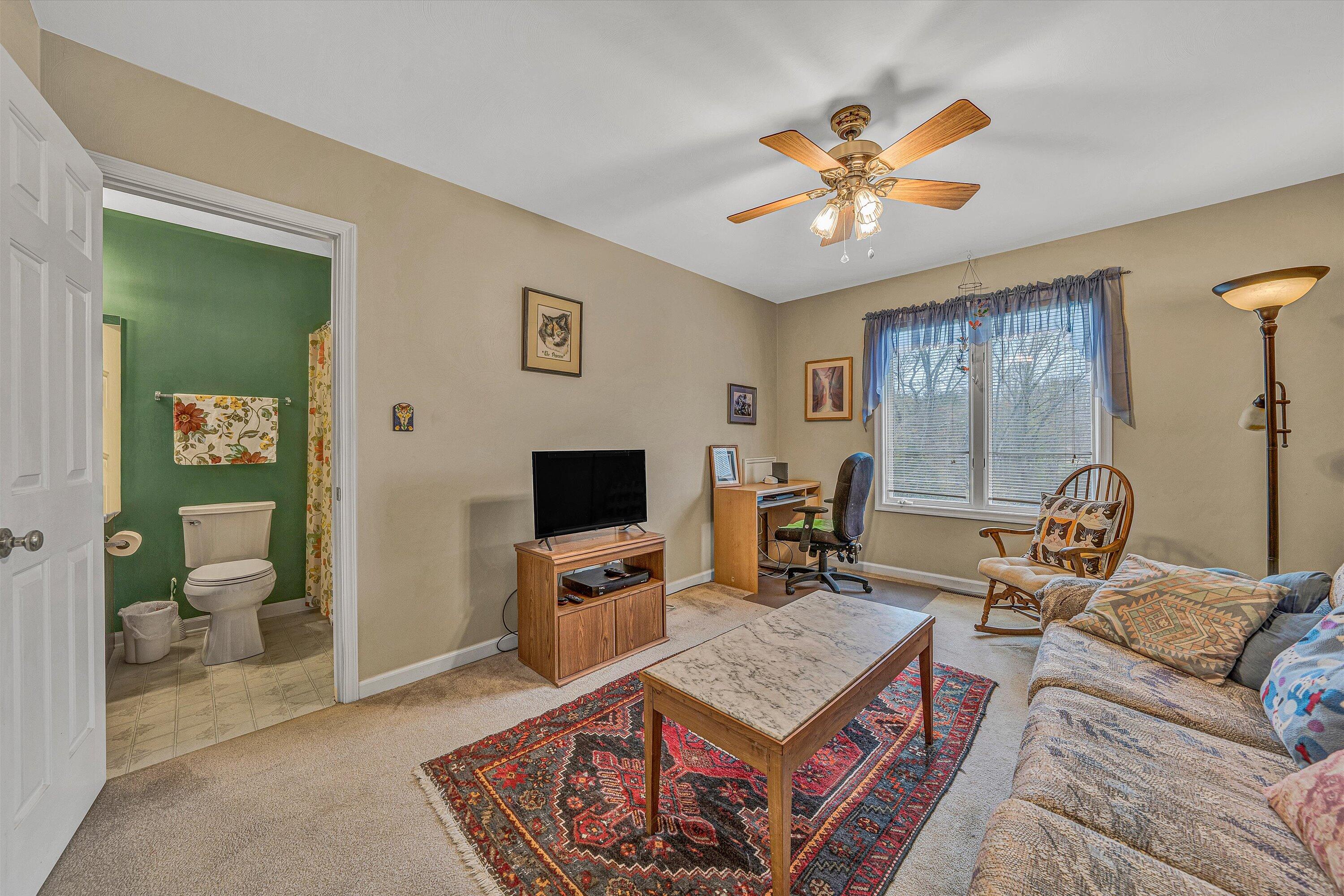 56 Scarlet Street Hardy, VA 24101 - Photo 20 of 42 a living room with furniture a chandelier and a flat screen tv