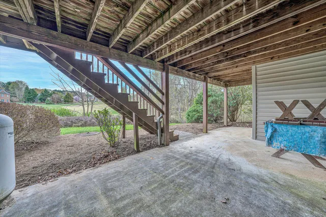 a view of a house with a yard and potted plants