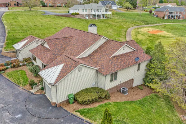 an aerial view of a house with garden space and street view