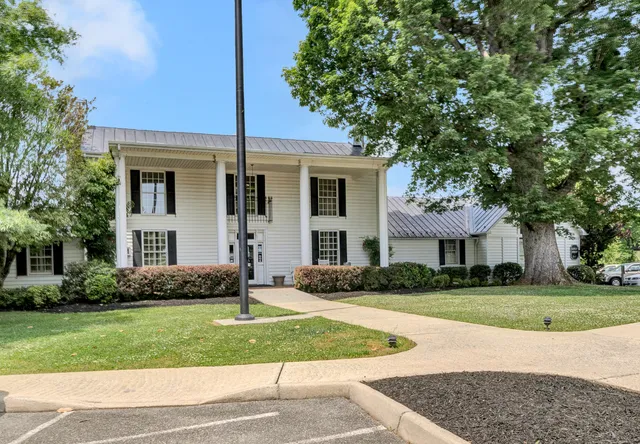a backyard of a house with a yard and fountain