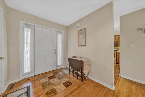 a workspace room with wooden floor and chair