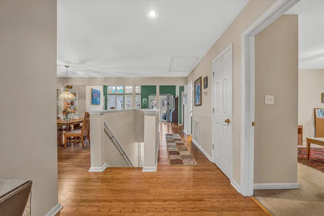 a view of a living room with wooden floor and a floor to ceiling window