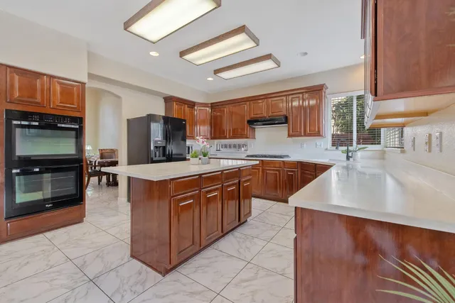 a bedroom with a bed and a ceiling fan