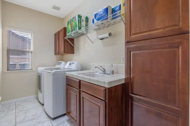 a spacious bathroom with a granite countertop sink a mirror and shower