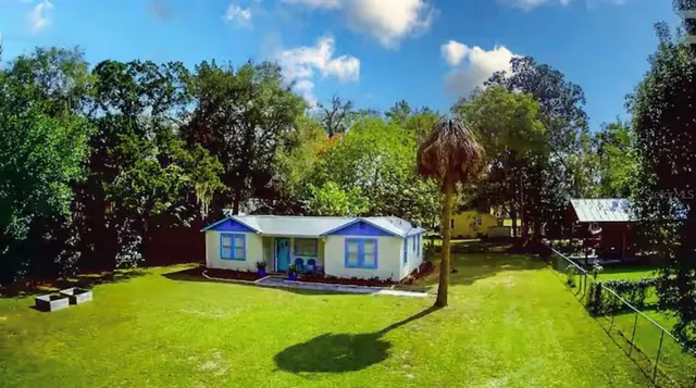 a front view of a house with yard swimming pool and outdoor seating
