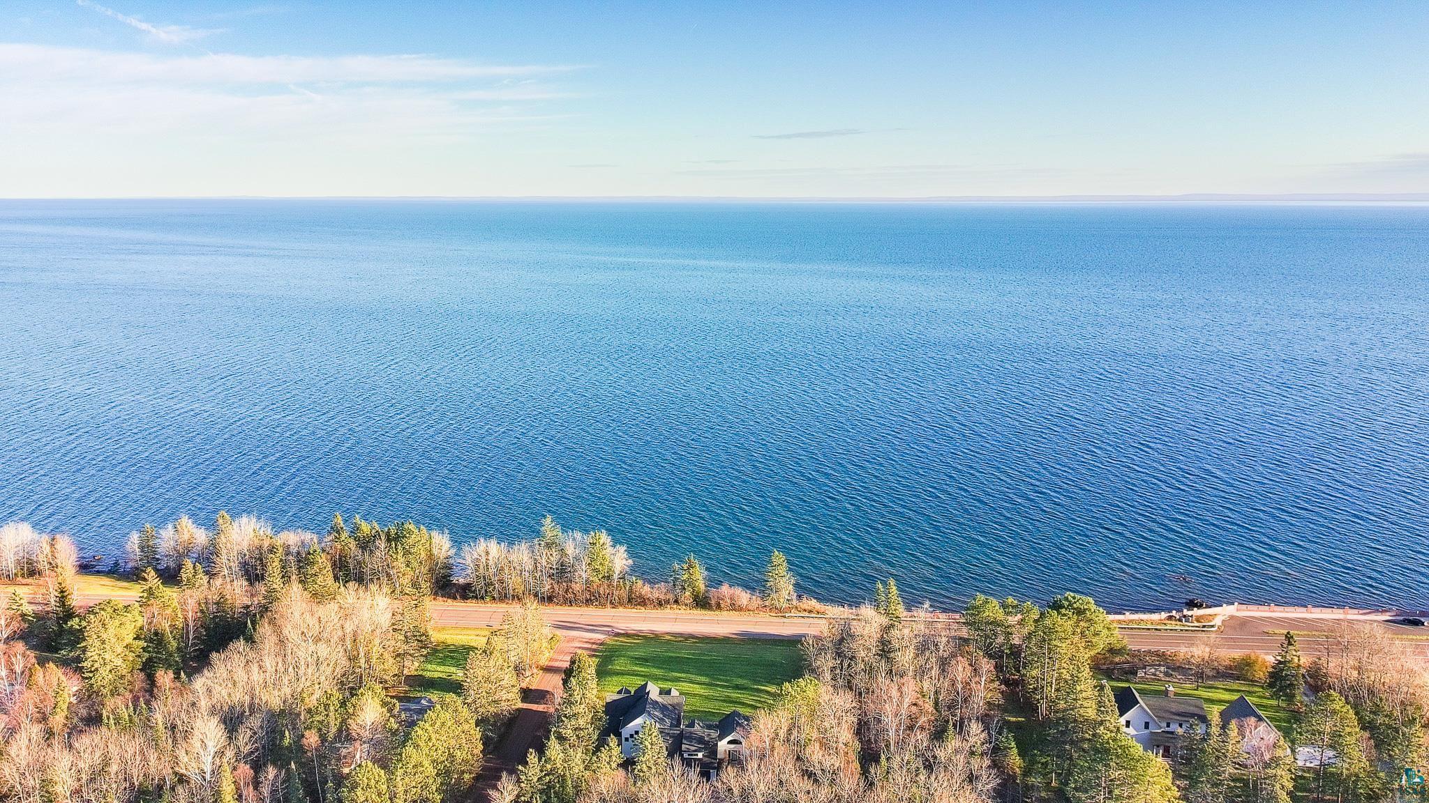 5163 Greenwood Road Duluth, MN 55804 - Photo 3 of 10 Expansive water frontage with a clear blue sky overhead