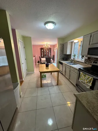 a view of a kitchen with kitchen island granite countertop lots of counter top space
