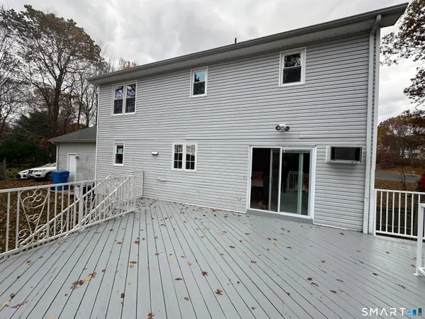 a view of backyard with deck and trees