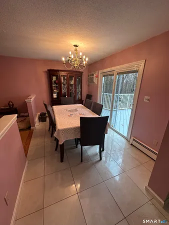 a view of a dining room with furniture and chandelier