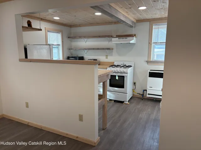 a kitchen with stainless steel appliances a refrigerator and a stove top oven
