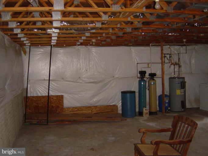 9463 Shiloh Church Road Rixeyville, VA 22737 - Photo 5 of 7 a room with water heater and wooden cabinets