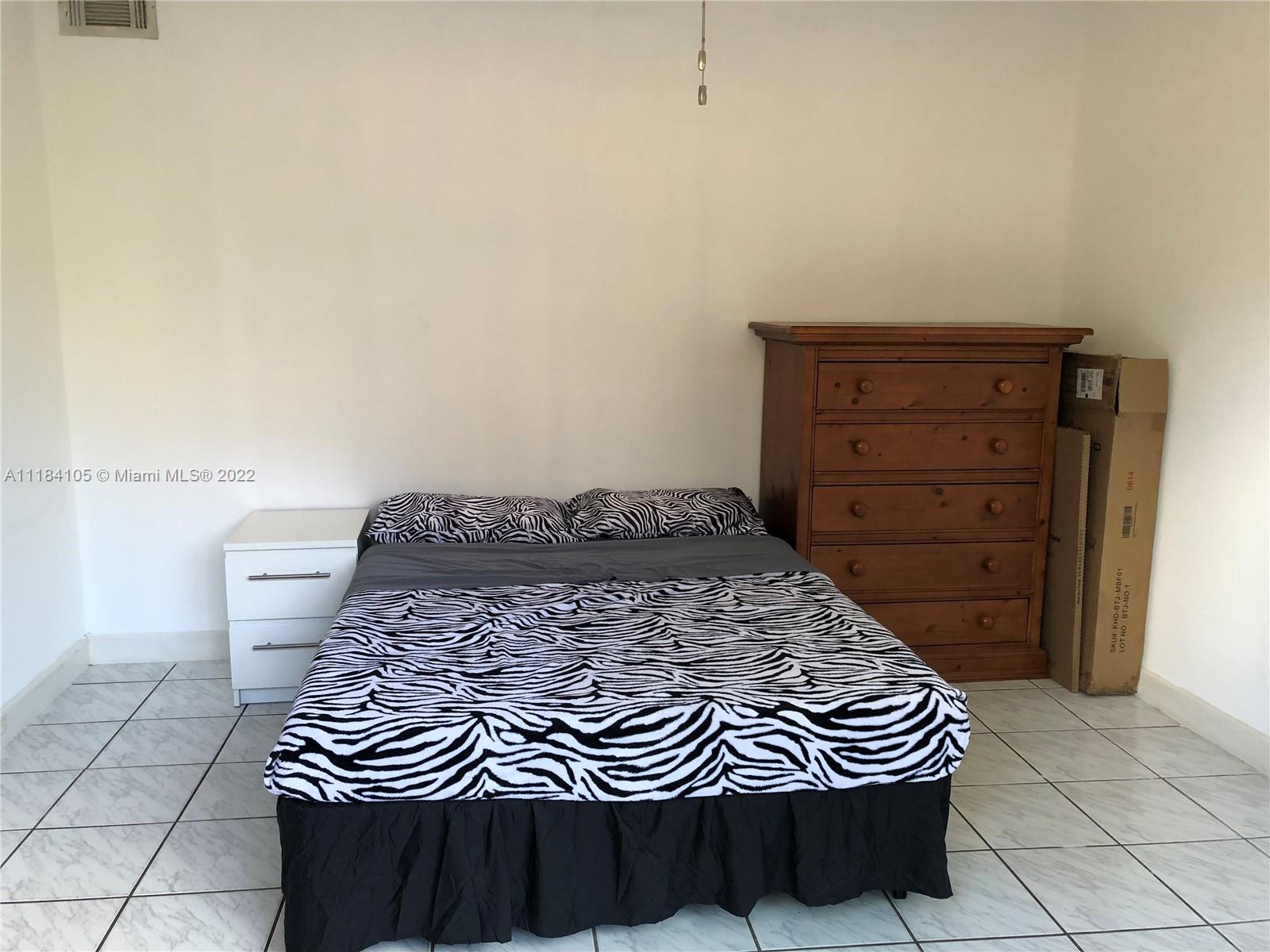 Kendall Miami, FL 33173 - Photo 17 of 26 a bed sitting in a bedroom and dresser