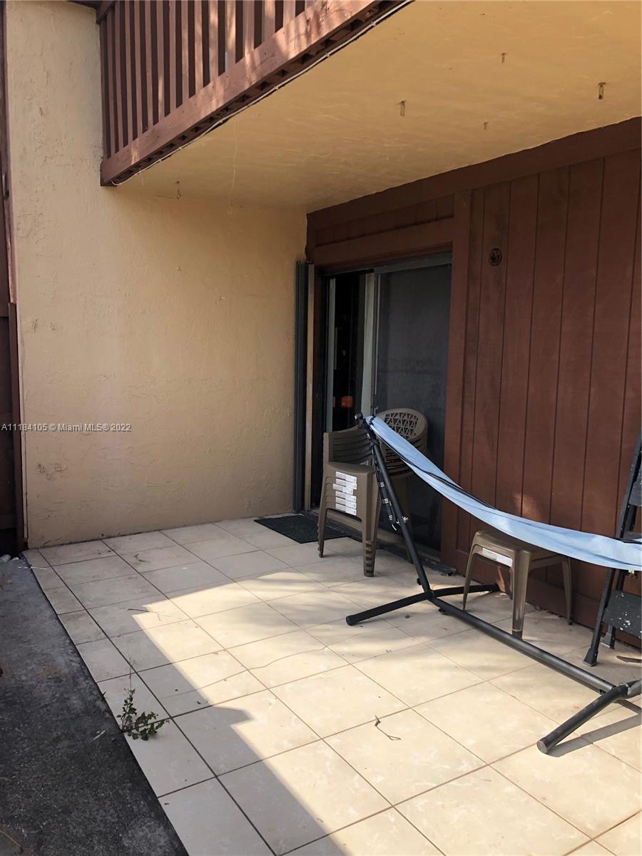 Kendall Miami, FL 33173 - Photo 20 of 26 a wooden bench sitting in front of a building