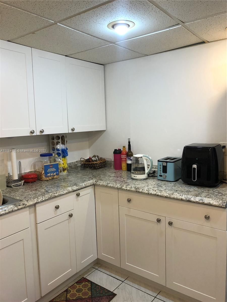 Kendall Miami, FL 33173 - Photo 4 of 26 a kitchen with granite countertop white cabinets and white appliances