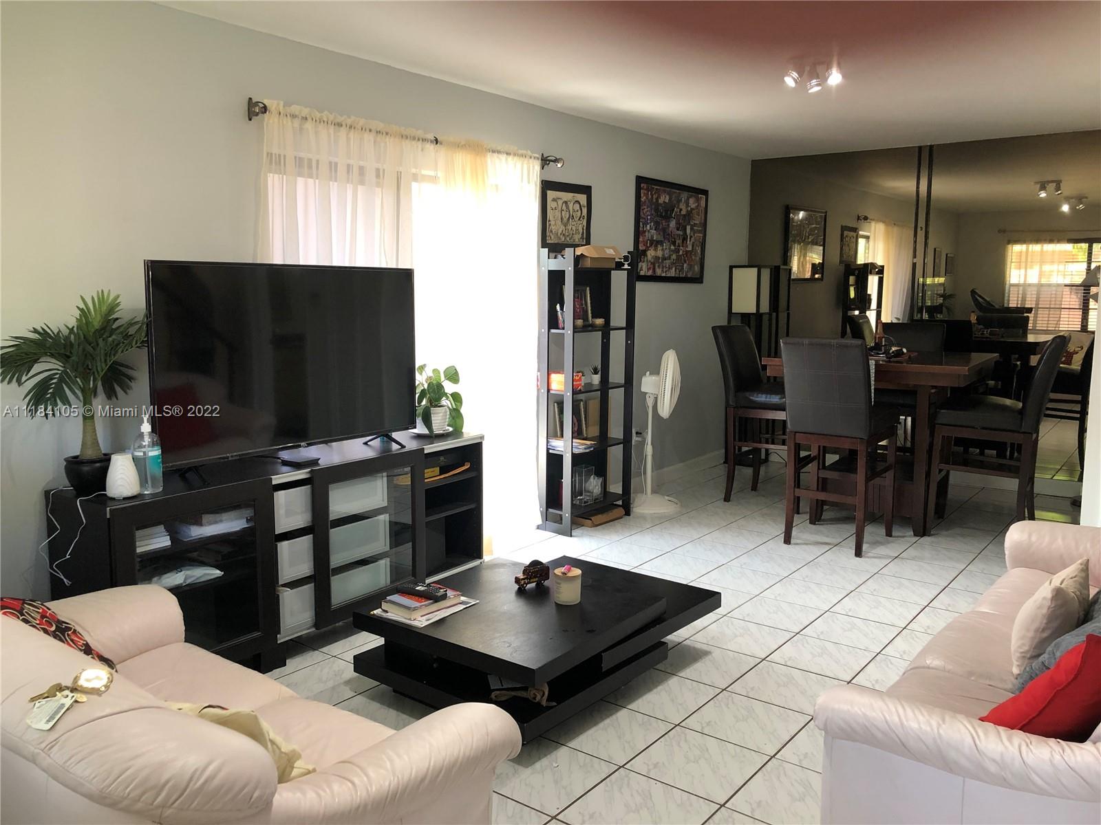 Kendall Miami, FL 33173 - Photo 6 of 26 a living room with furniture and a flat screen tv