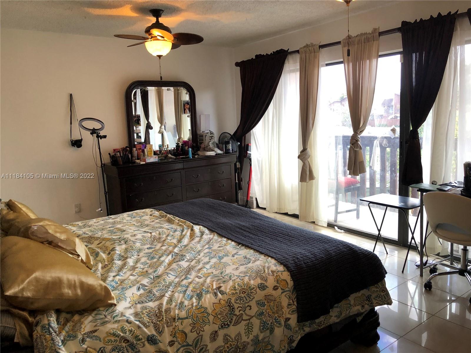 Kendall Miami, FL 33173 - Photo 7 of 26 a bedroom with a bed and a chandelier