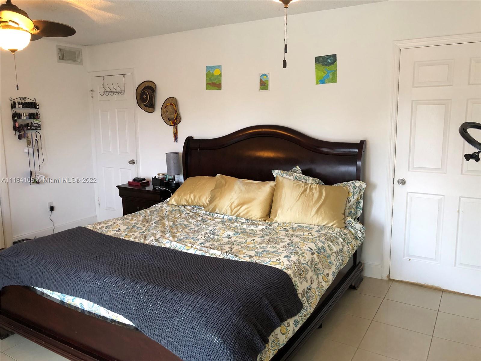 Kendall Miami, FL 33173 - Photo 8 of 26 a bedroom with a bed and cabinets