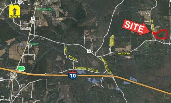 a backyard of a house with lots of green space and fountain