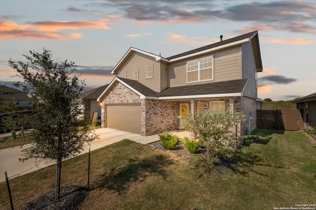 a view of house with yard and sitting area