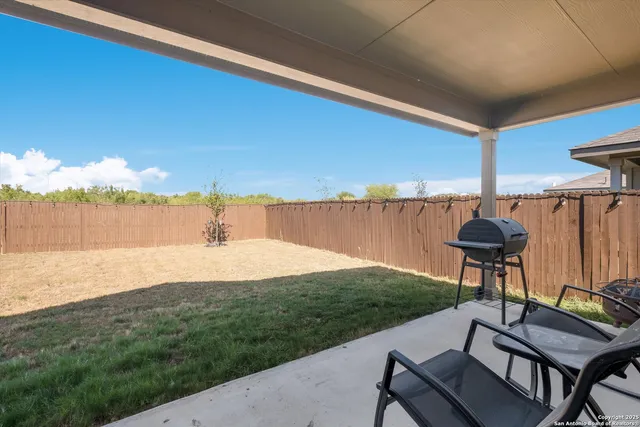 a view of a backyard with plants and a lake view