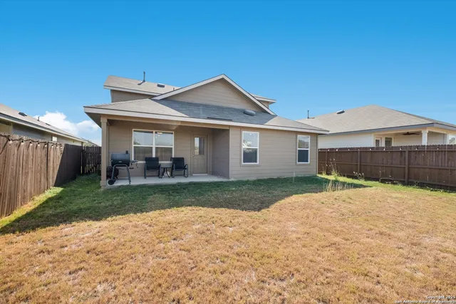 a view of a yard in front view of a house