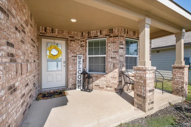 a front view of a house with outdoor seating