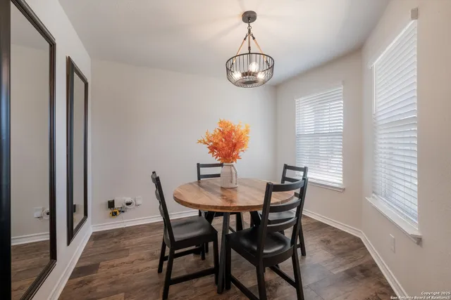 a view of a dining room with furniture wooden floor and chandelier