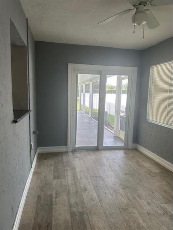 15109 Jackson Road Delray Beach, FL 33484 - Photo 5 of 14 an empty room with chandelier fan and windows