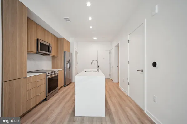 a kitchen with stainless steel appliances granite countertop a stove and a refrigerator