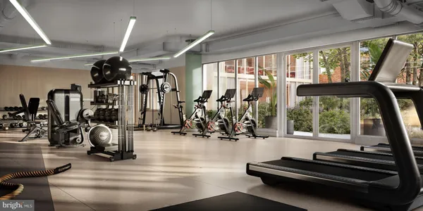 a room with lots of gym equipment and windows