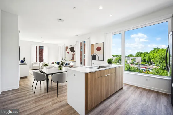 a living room with a sink cabinets and wooden floor