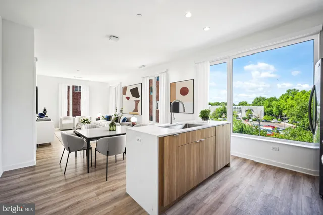 a living room with a sink cabinets and wooden floor