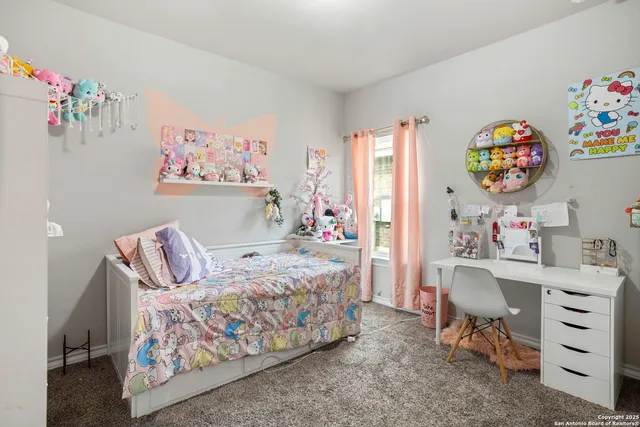 a bedroom with a bed and a desk