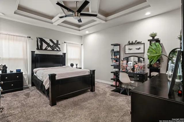 a bedroom with a bed a books bucket with a desk and chair