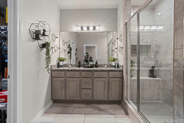 a bathroom with a sink vanity and a mirror
