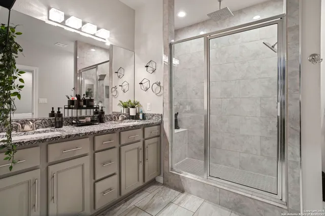 a bathroom with a shower sink and mirror