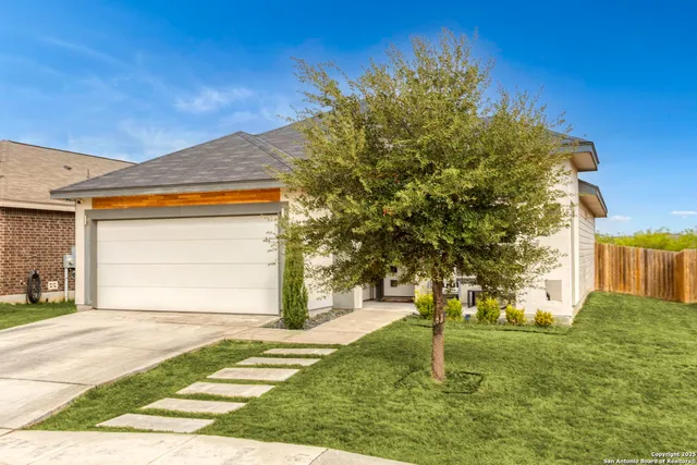 a house with huge green field in front of it