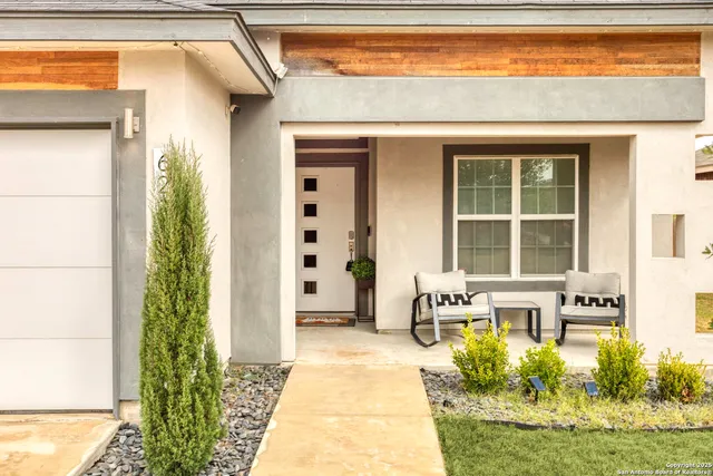 a front view of a house with a fountain