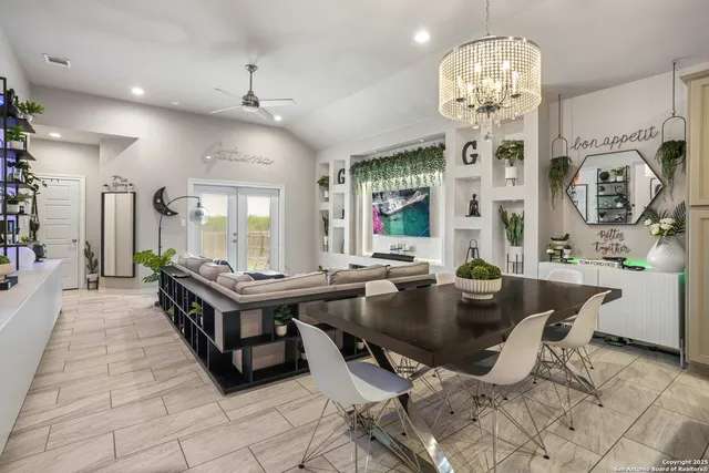 a view of a dining room with furniture a chandelier and wooden floor