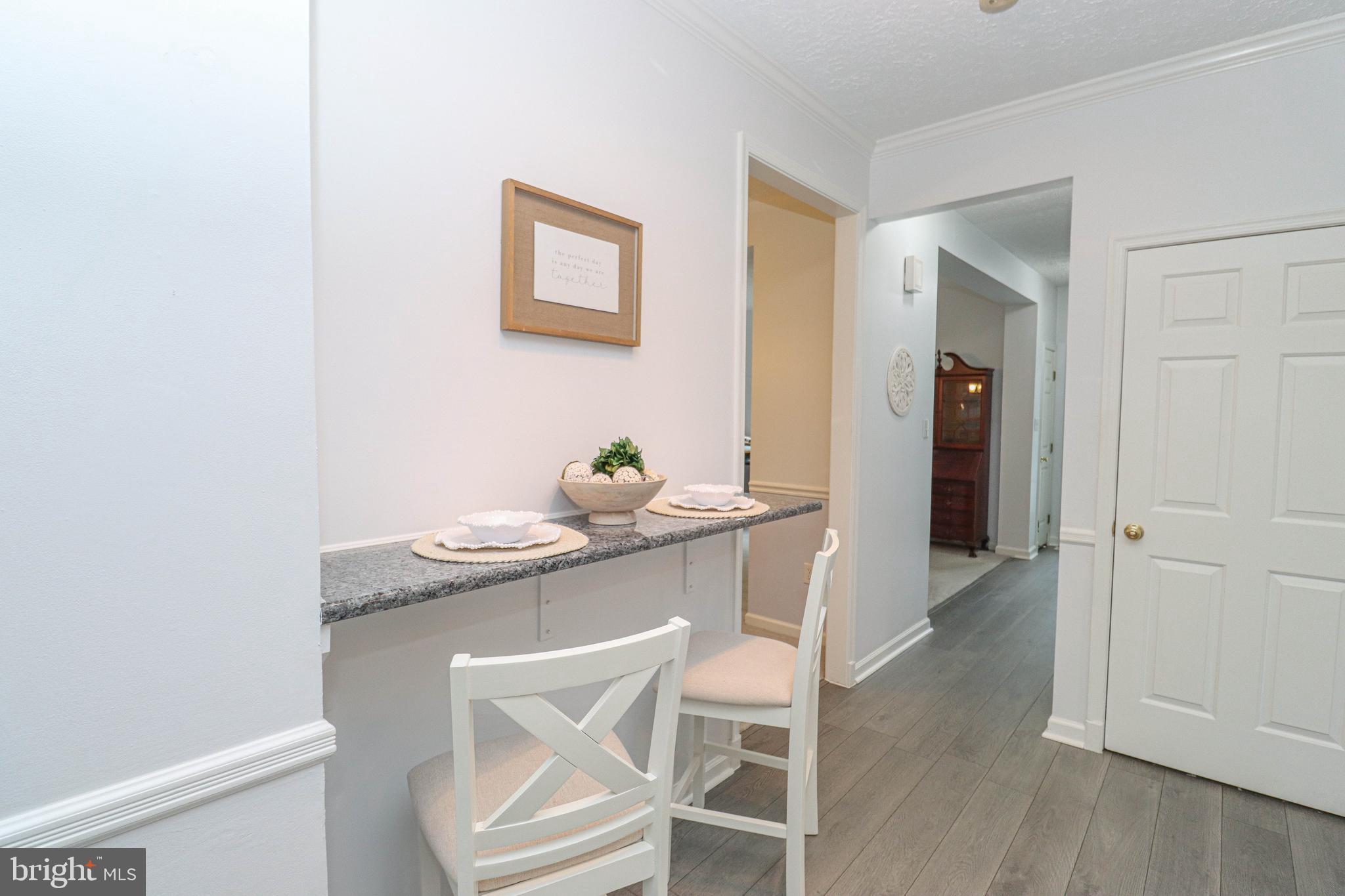 1724 Algonquin Road Frederick, MD 21701 - Photo 16 of 55 a dining room that has a sink and a chair with wooden floor